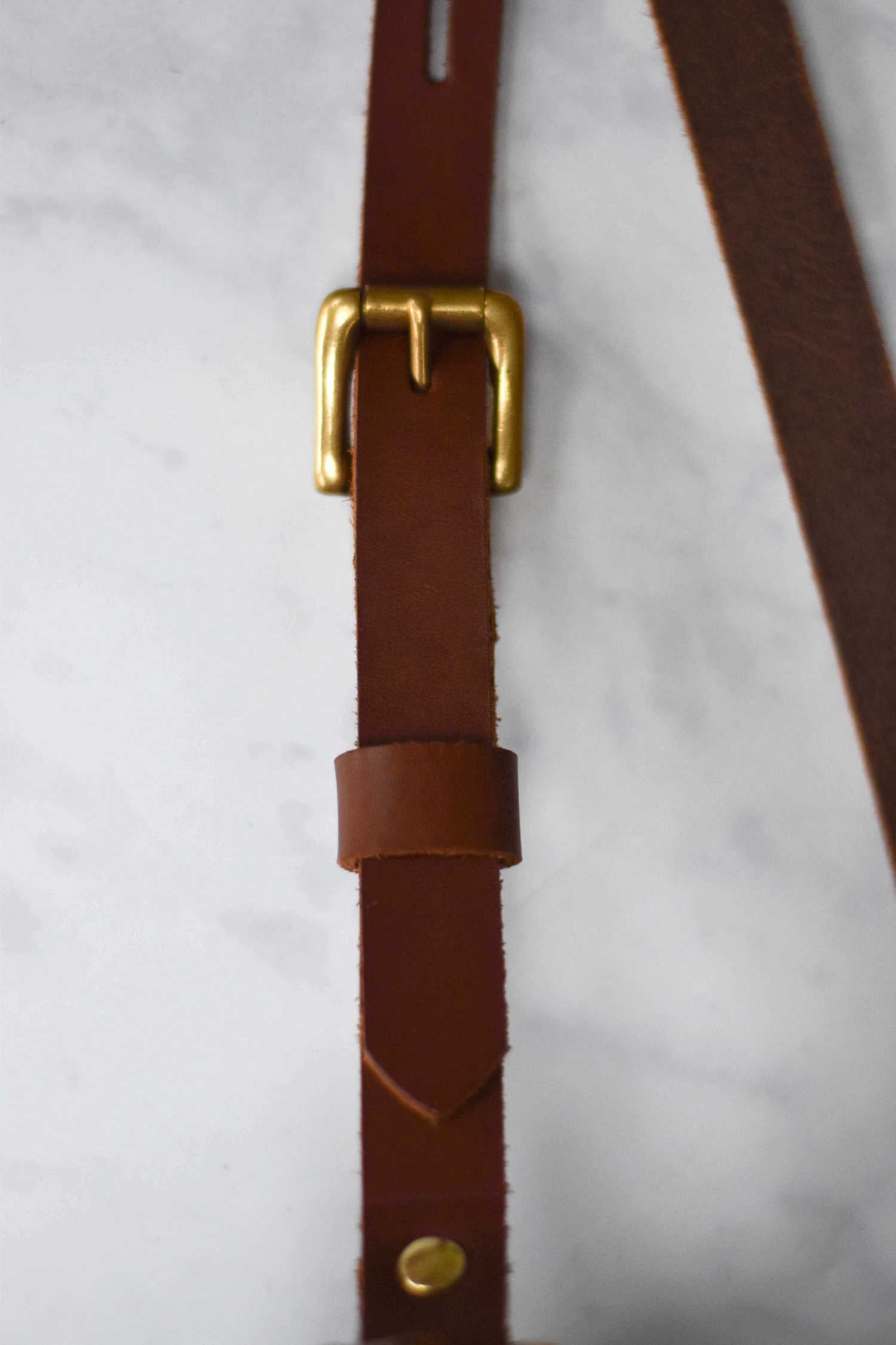 Adjustable leather shoulder outlet strap